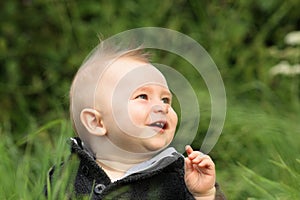 Happy baby boy outdoors