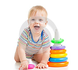 Happy baby boy playing with colorful toy