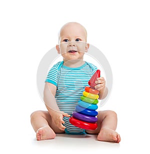 Happy baby boy playing with toy on white