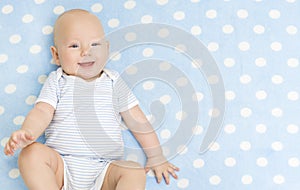 Happy Baby Boy, Smiling Infant Kid Portrait, Five Months Old Child lying on Blue