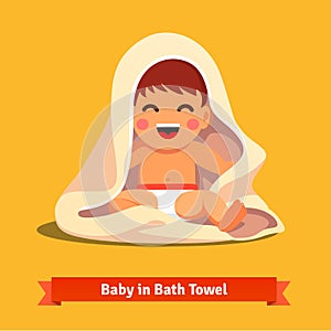 Happy baby boy toddler wrapped in bath towel