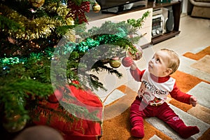 Happy baby by the Christmas tree