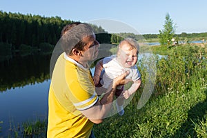 Happy baby in daddy`s arms