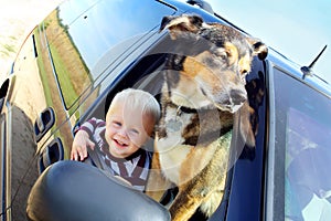 Happy Baby and Dog in Minivan Window