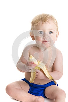 Happy baby eats banana