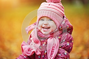 Happy baby girl child outdoors in the park in autumn