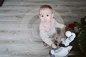 happy baby girl decorating the Christmas tree