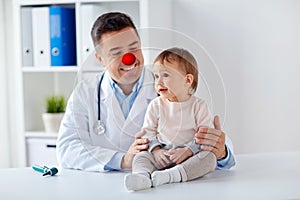 Happy baby girl at doctor on red nose day