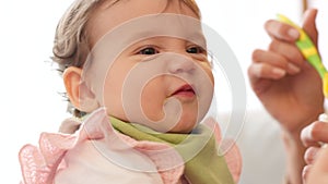 Happy, baby and girl with food face, cute smile in funny and silly breakfast time eating at home. Little child spoon fed