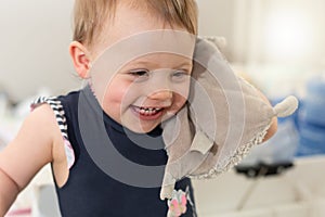 Happy baby girl with her cuddly toy