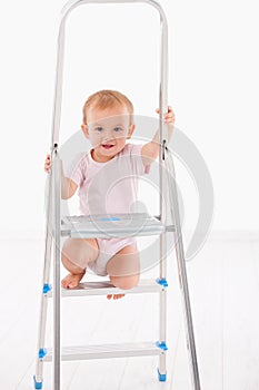 Happy baby girl on ladder