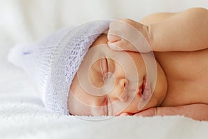 Happy baby girl new born sleeping in hat