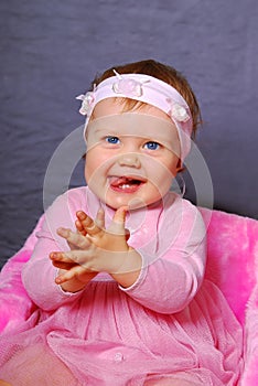 Happy baby girl in pink dress