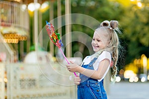 Happy baby girl playing in amusement Park, happy childhood