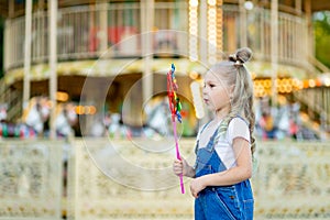 Happy baby girl playing in amusement Park, happy childhood