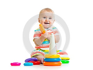 Happy baby girl playing with colorful toy