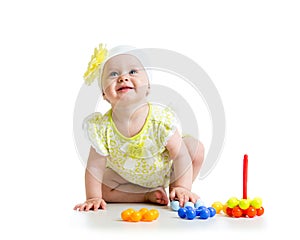 Happy baby girl playing with colorful toy