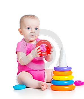 Happy baby girl playing toy