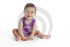 Happy Baby girl sitting on the floor