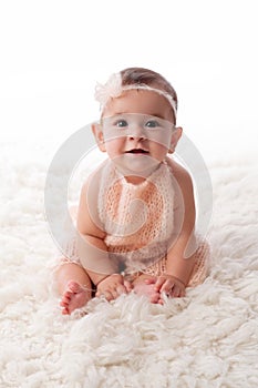 Happy Baby Girl Wearing a Peach Colored, Kintted Mohair Romper photo