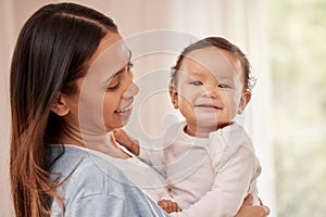 Happy baby, happy mom. Portrait of an adorable baby girl being held by her mother at home.