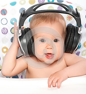 Happy baby with headphones listening to music