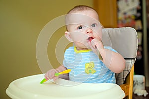 Happy baby infant boy eating meal