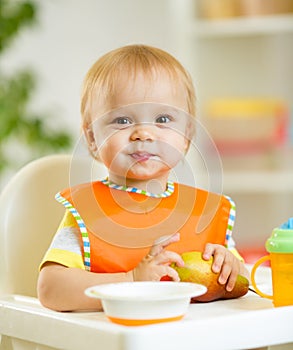 Happy baby kid boy toddler eating itself with
