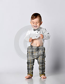 Happy baby. Little boy in a white shirt and bow tie. Children portrait. Stylish man in fashionable a bow-tie.