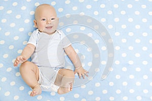 Happy Baby lying on Blue Carpet Background, Smiling Infant Kid