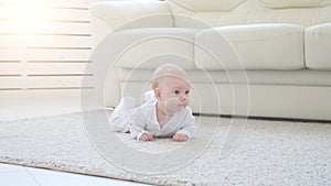 Happy Baby Lying on Carpet Background, Smiling Infant Kid girl in White Clothing