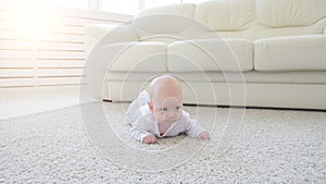 Happy Baby Lying on Carpet Background, Smiling Infant Kid girl in White Clothing