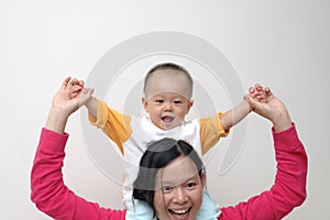 Happy baby on mother's shoulders