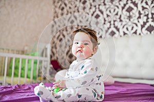 happy baby after a nap. healthy sleep, the guarantee of a vigorous child. Cute little baby boy, relaxing in bed after bath,