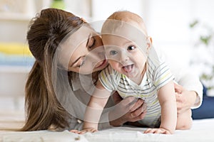 Happy baby near to mom in room