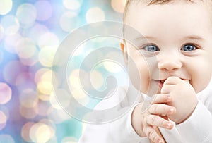 Happy baby over blue holidays lights background