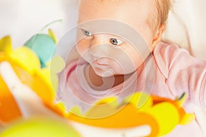 Happy baby playing with children's musical mobile toy