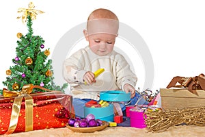 Happy baby playing with a Christmas gift