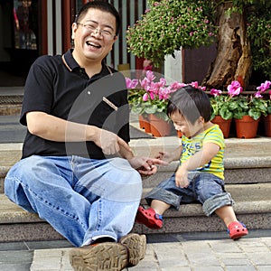 Happy baby is playing with his father