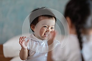 Happy baby playing and laughing together at home.Smile cute baby girl playing and fun with friend or sister.Positive and good