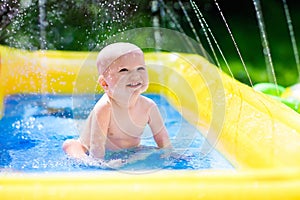 Happy baby playing in swimming pool