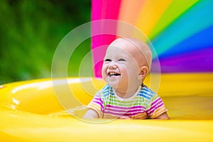 Happy baby playing in swimming pool