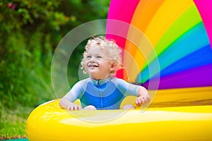 Happy baby playing in swimming pool