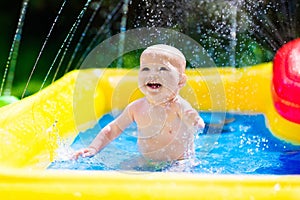 Happy baby playing in swimming pool