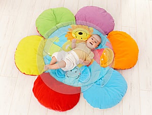 Happy baby on playmat