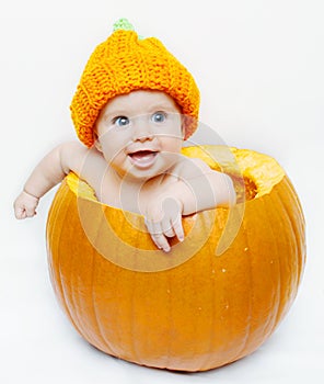 Happy baby in a pumpkin