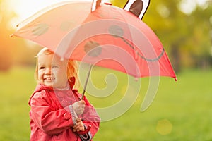 Happy baby with red umbrella