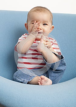 Happy baby's teething with her hands