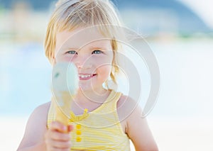 Happy baby showing ice cream