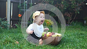 Happy Baby Sitting With Soccer Black White Classic Ball On Green Grass. Adorable Infant Baby Playing Outdoors In